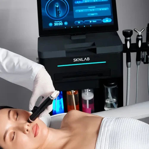 Person receiving a skincare treatment with Skinlab equipment in a clinical setting.